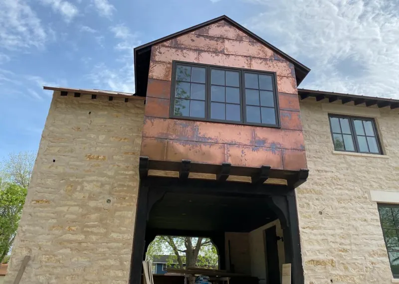 Copper metal panel facade on a stone building for Metal Roof Coating in Hockinson